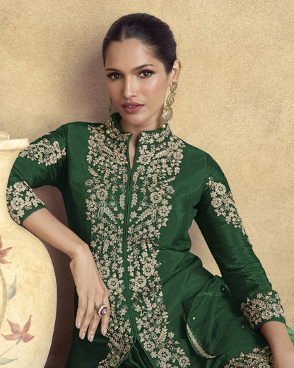 Woman wearing a green embroidered traditional outfit against a beige background