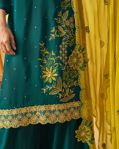 Teal outfit with gold embroidery and yellow dupatta