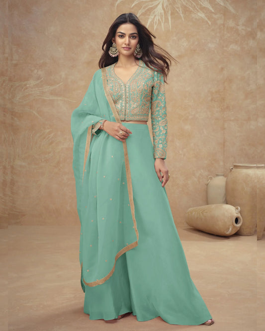 Woman wearing a green traditional outfit with a beige background