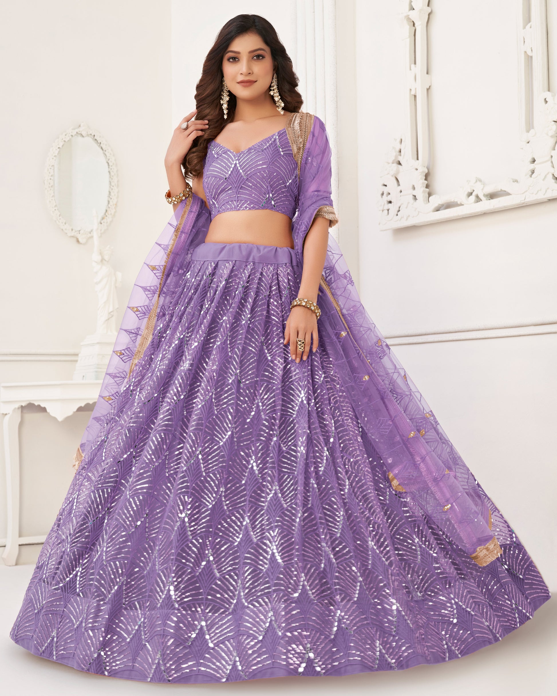 Woman wearing a purple lehenga with a white background