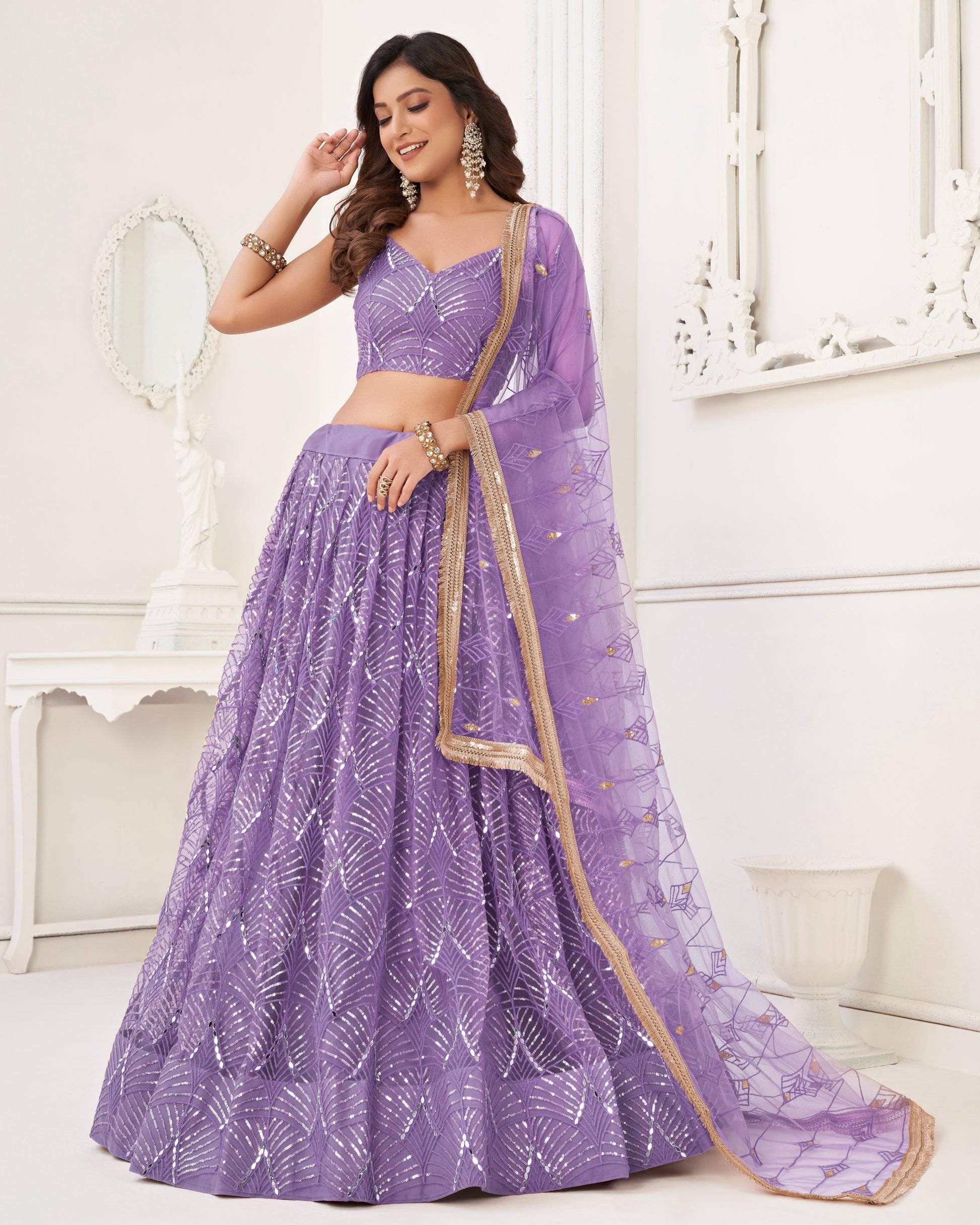 Woman wearing a purple saree with a white background