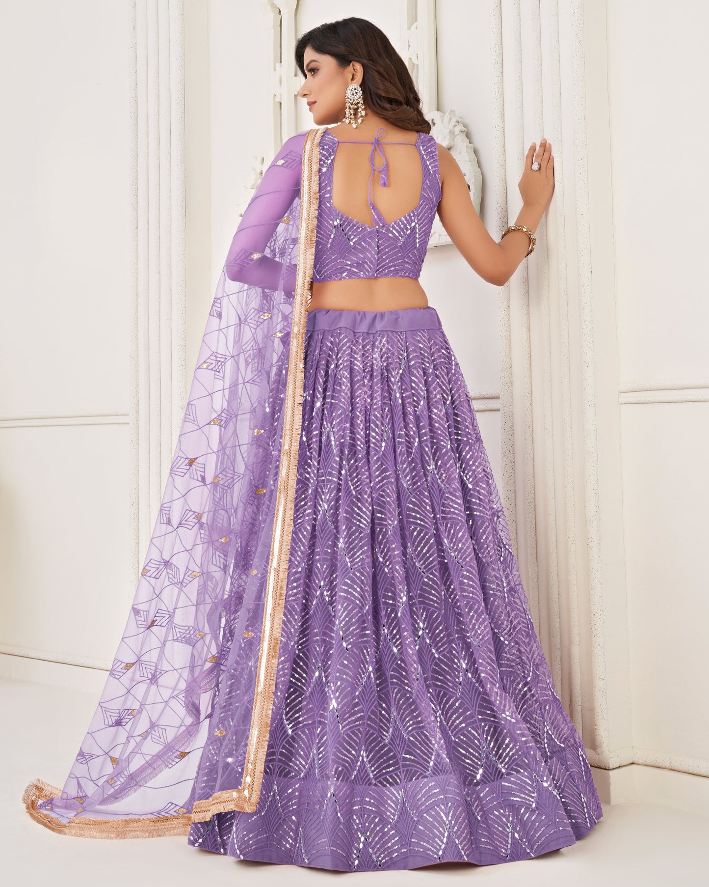 Woman wearing a purple traditional outfit with a white background