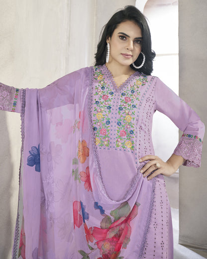 Woman wearing a light purple embroidered dress with a matching dupatta in a neutral setting