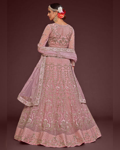 Pink embroidered traditional outfit on a dark background
