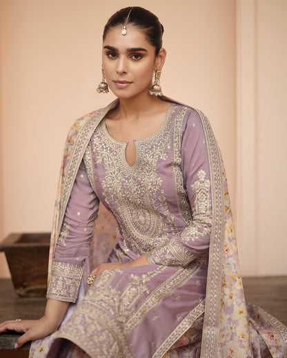 Woman wearing a traditional outfit with intricate patterns and embroidery.