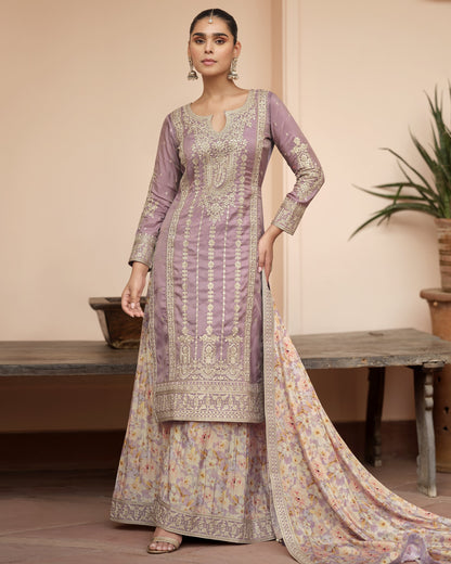 Woman wearing a traditional outfit with a floral design in a home setting