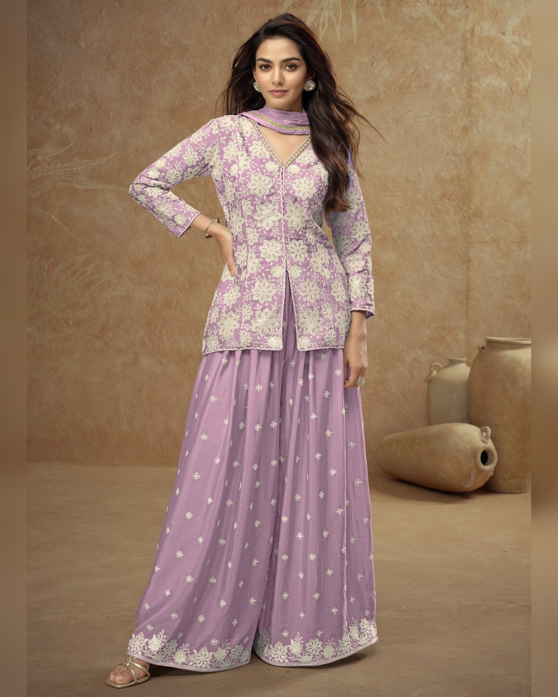 Woman wearing a purple traditional outfit with a beige background