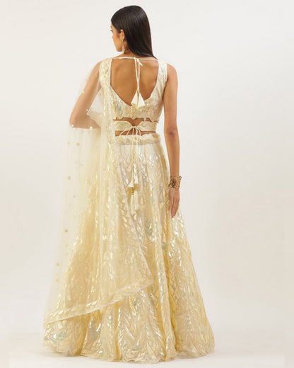 Woman wearing a gold evening gown with a white background