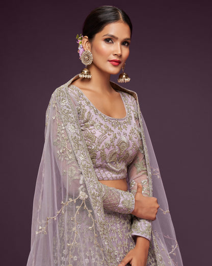 Woman in traditional embroidered outfit with a purple background