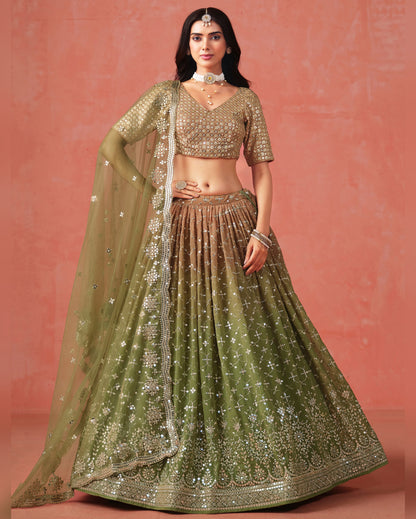 Woman wearing a traditional green and gold outfit against a pink background