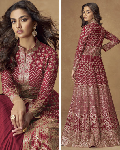 Woman wearing a red and gold patterned dress against a beige background