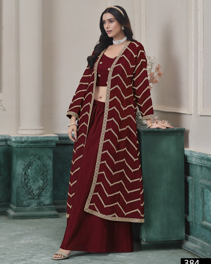Woman wearing a maroon and gold traditional outfit with a chevron pattern in an elegant indoor setting.
