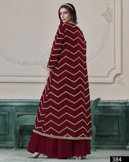 Woman wearing a maroon and gold chevron patterned dress in an elegant interior setting.