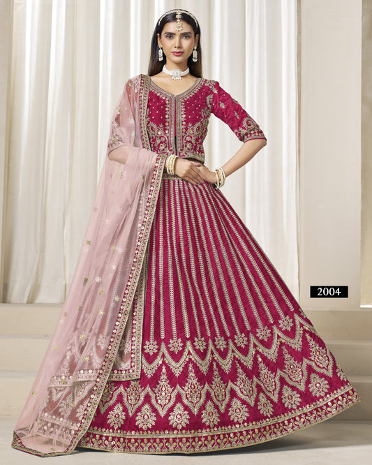 Woman wearing a traditional pink and red embroidered dress with a matching dupatta.