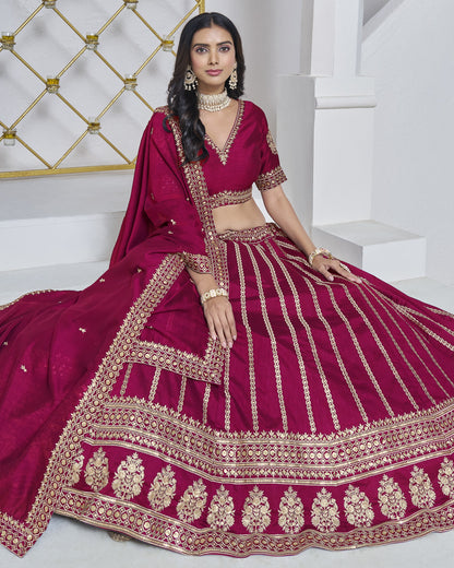 Woman wearing a maroon embroidered traditional outfit on a white background