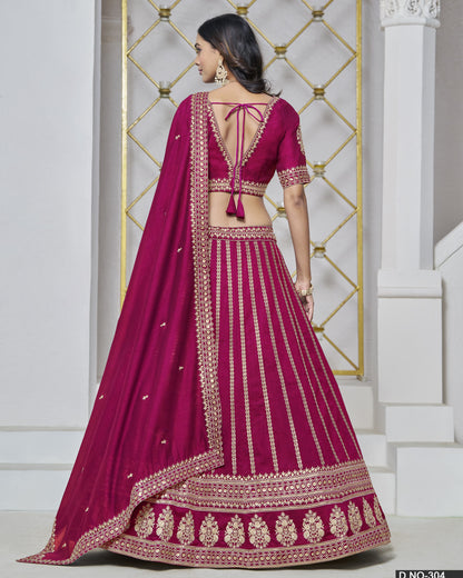 Woman wearing a magenta embroidered traditional outfit with a white background