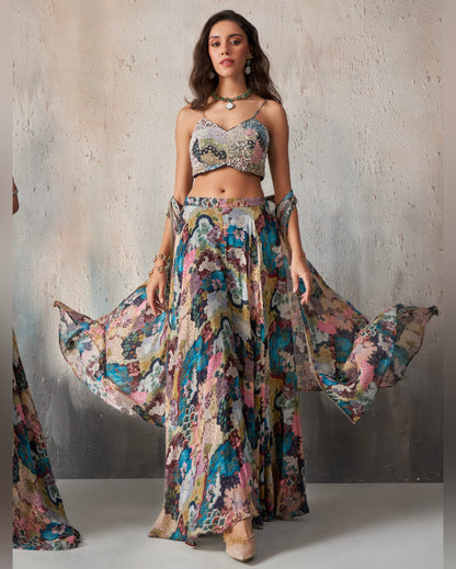 Woman wearing a colorful floral outfit against a neutral background