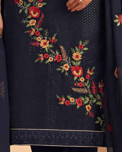 Navy blue fabric with floral embroidery in red, yellow, and green.