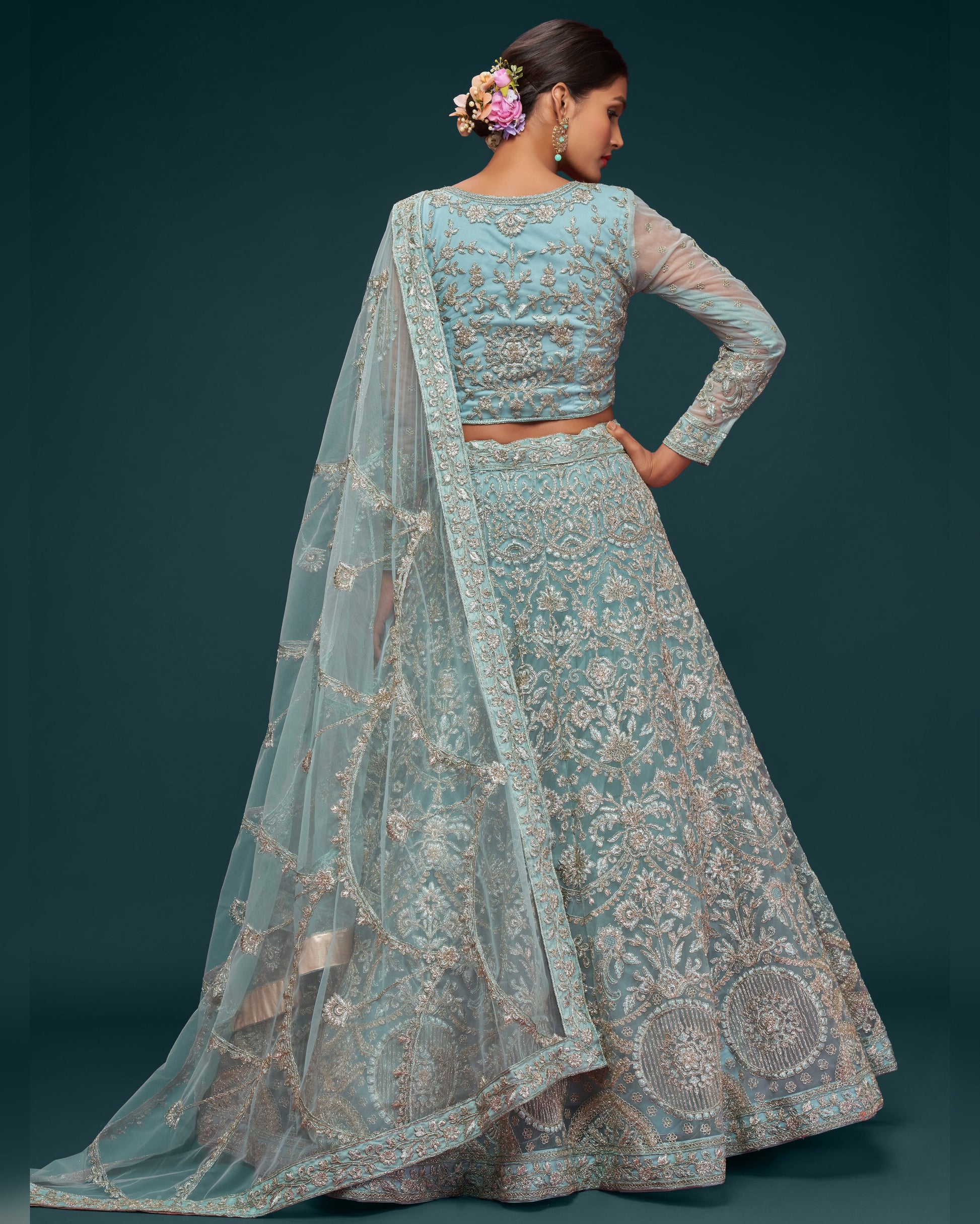 Woman wearing a traditional embroidered outfit with a dark background