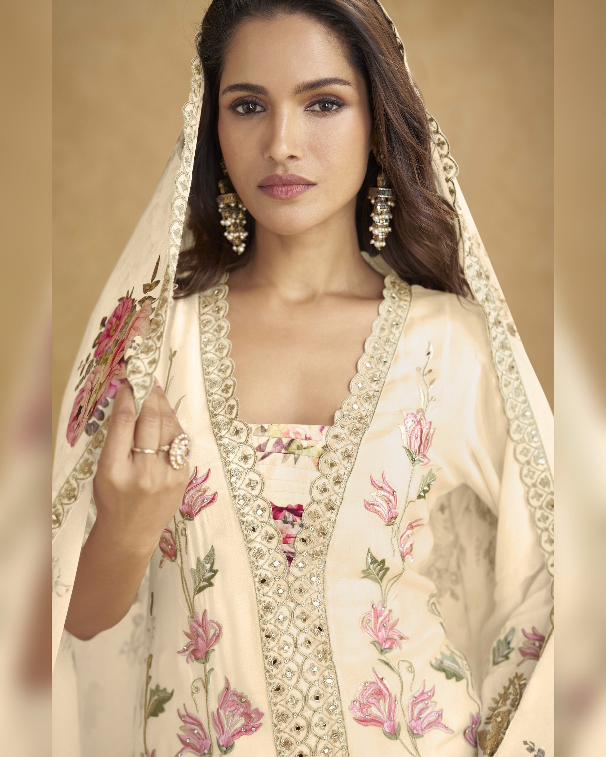 Woman wearing a traditional embroidered outfit with a beige background
