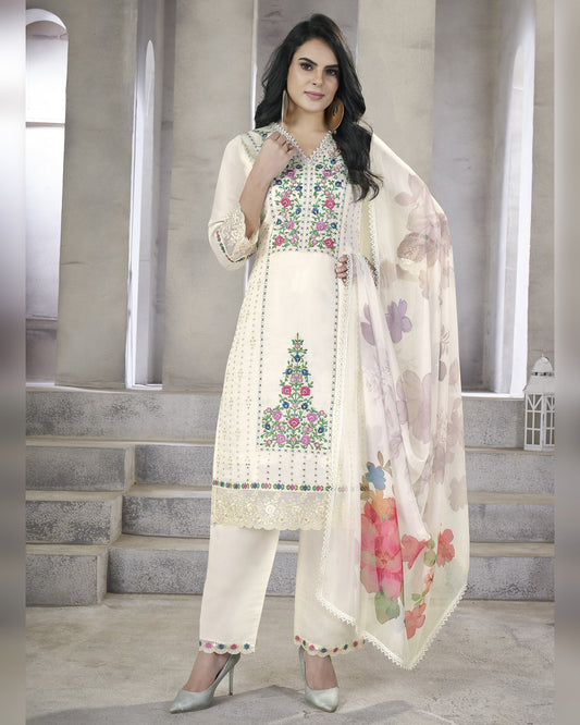 Woman wearing a traditional outfit with floral embroidery in an indoor setting