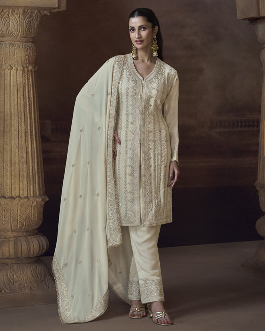 Woman wearing a traditional outfit with a dupatta in an elegant setting