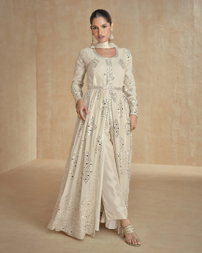 Woman wearing a cream embroidered outfit on a beige background