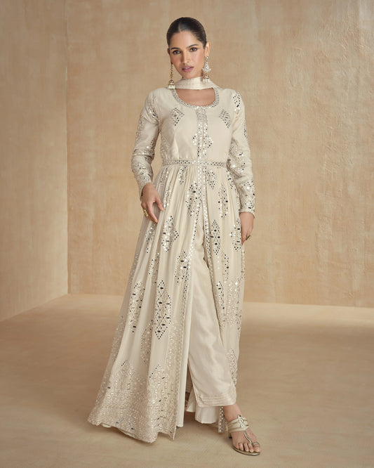 Woman wearing a cream embroidered outfit on a beige background