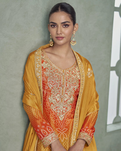 Woman wearing a traditional outfit with intricate patterns against a neutral background