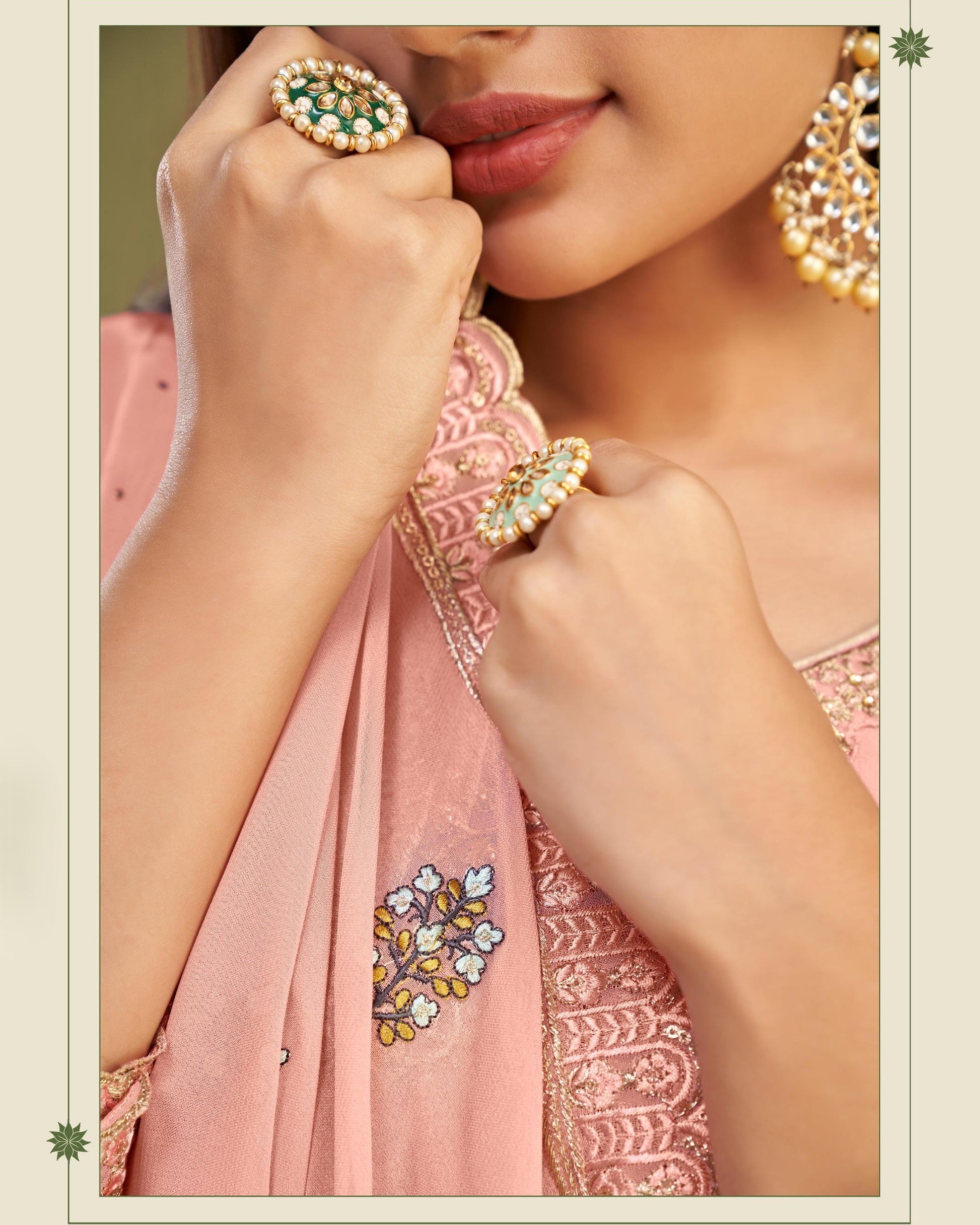 Close-up of a person wearing jewelry with a pink embroidered garment