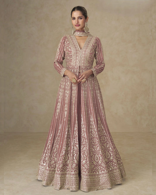 Woman wearing a traditional embroidered dress against a neutral background