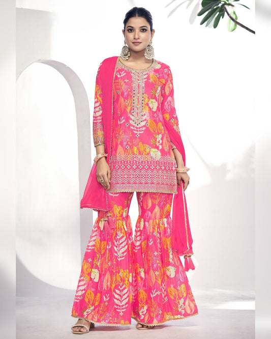 Woman wearing a pink traditional outfit with floral patterns on a white background