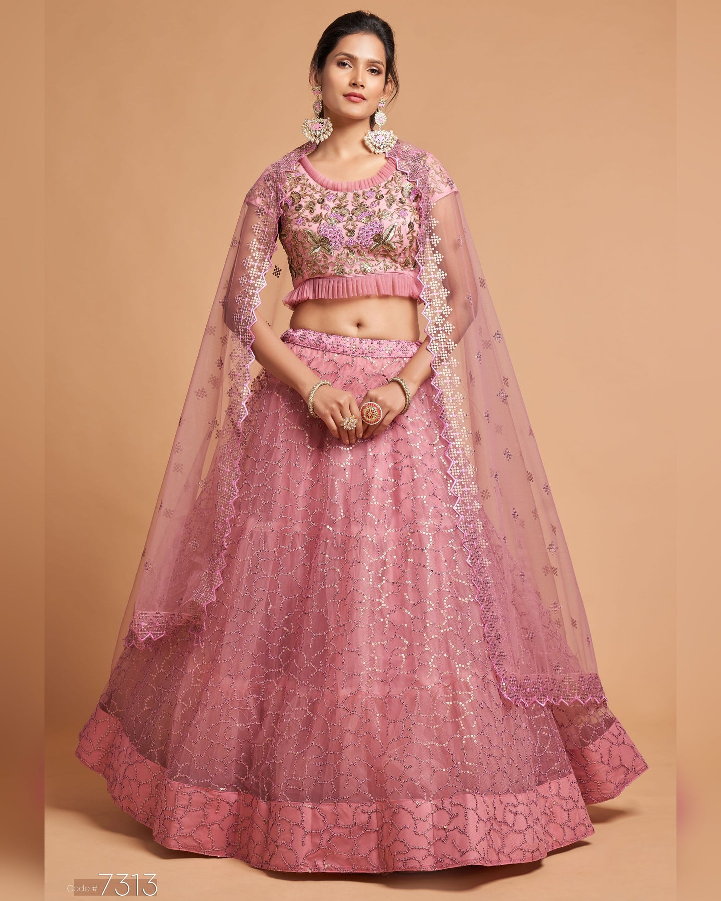 Woman wearing a pink traditional outfit with a beige background
