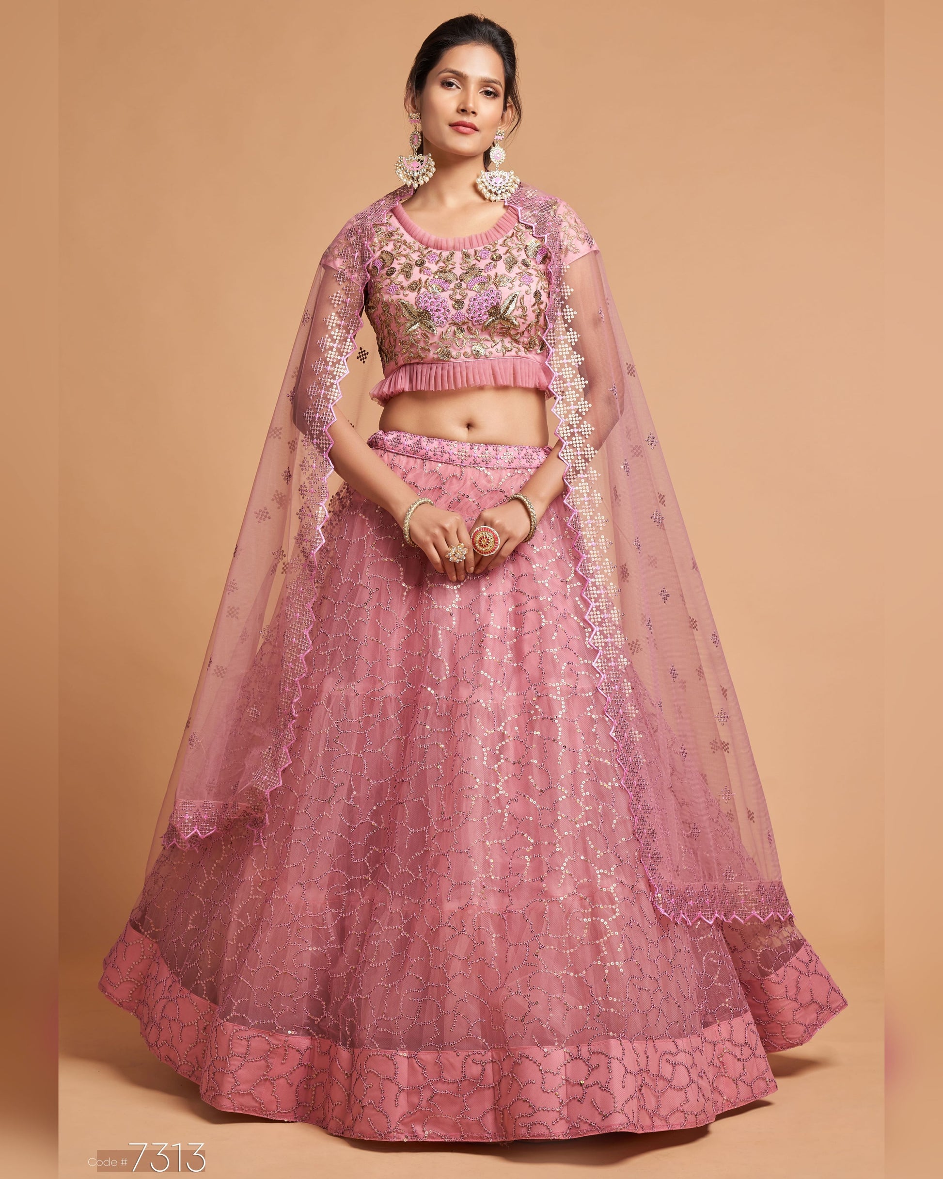 Woman wearing a pink traditional outfit with a beige background