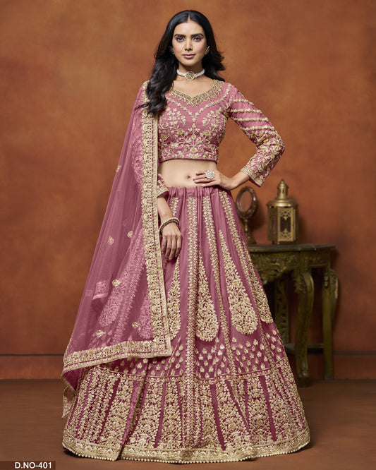 Woman in a traditional pink and gold embroidered outfit against a brown background