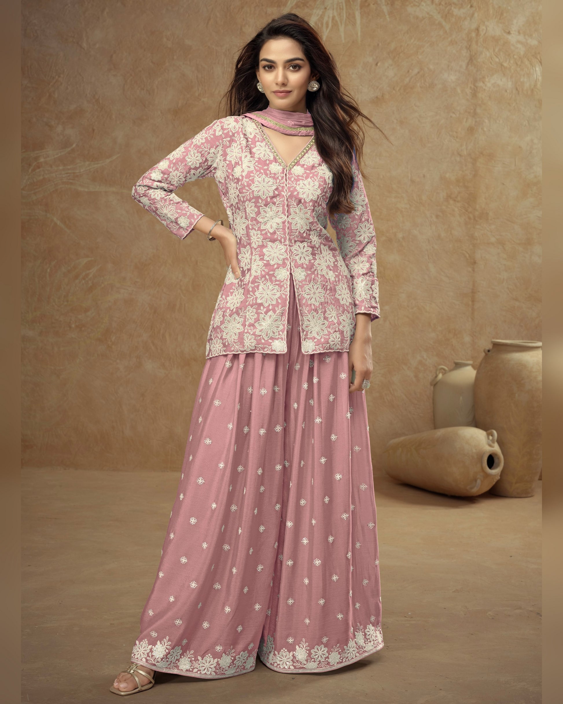 Woman wearing a pink floral outfit with a beige background