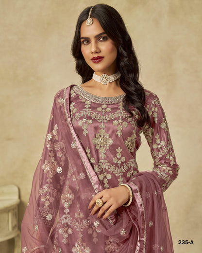 Woman wearing a traditional embroidered outfit with a beige background