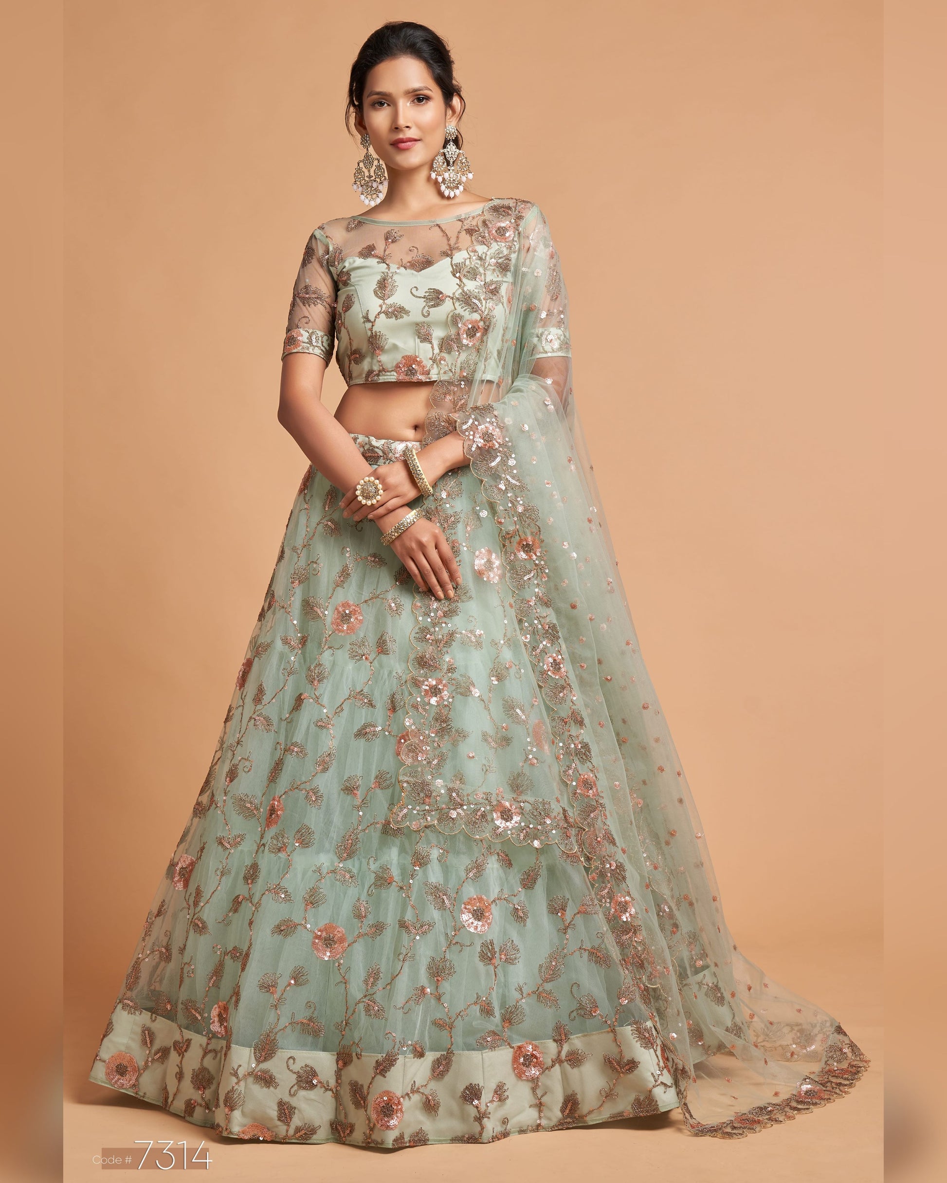 Woman wearing a floral lehenga on a beige background