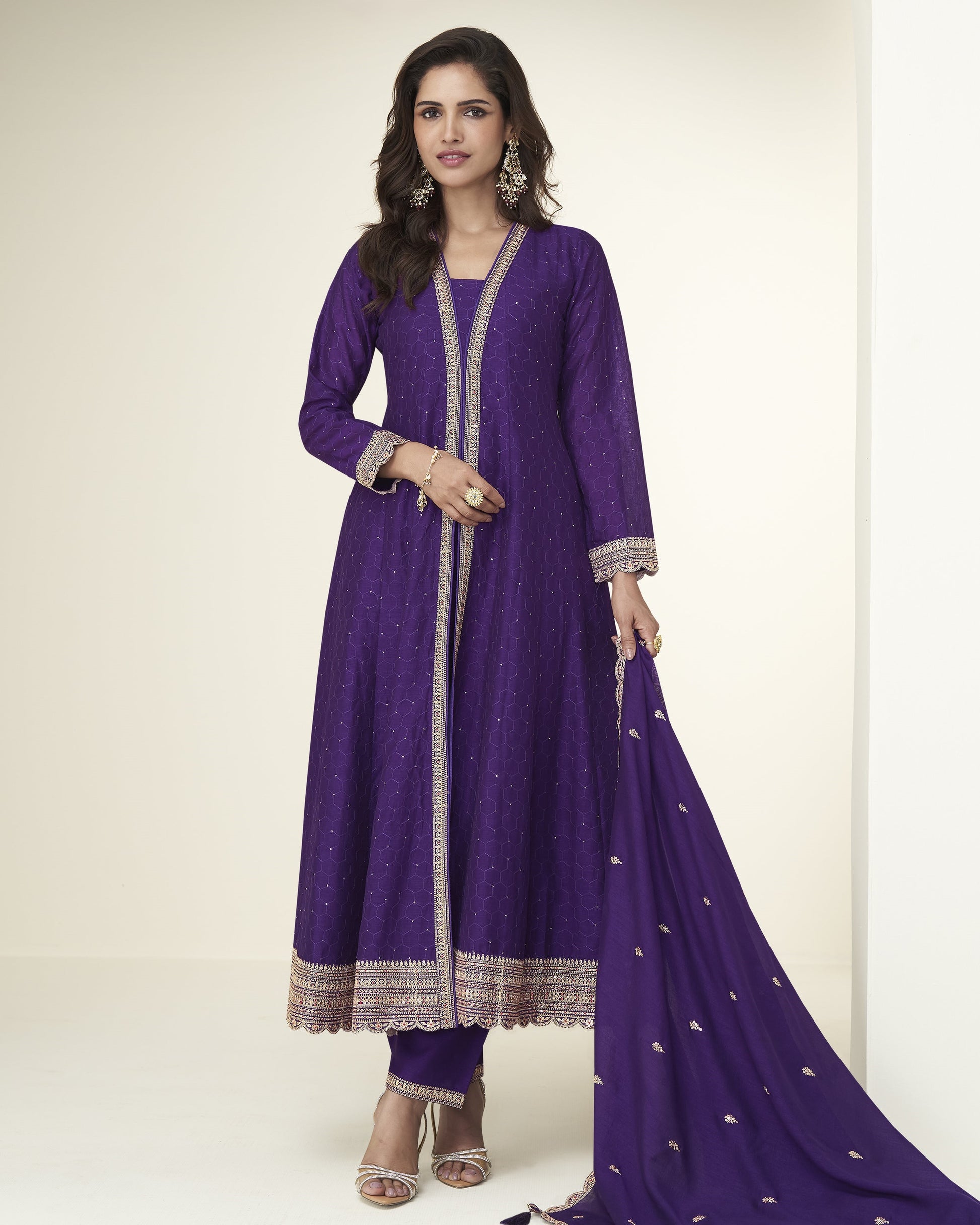 Woman wearing a purple traditional outfit with a white background