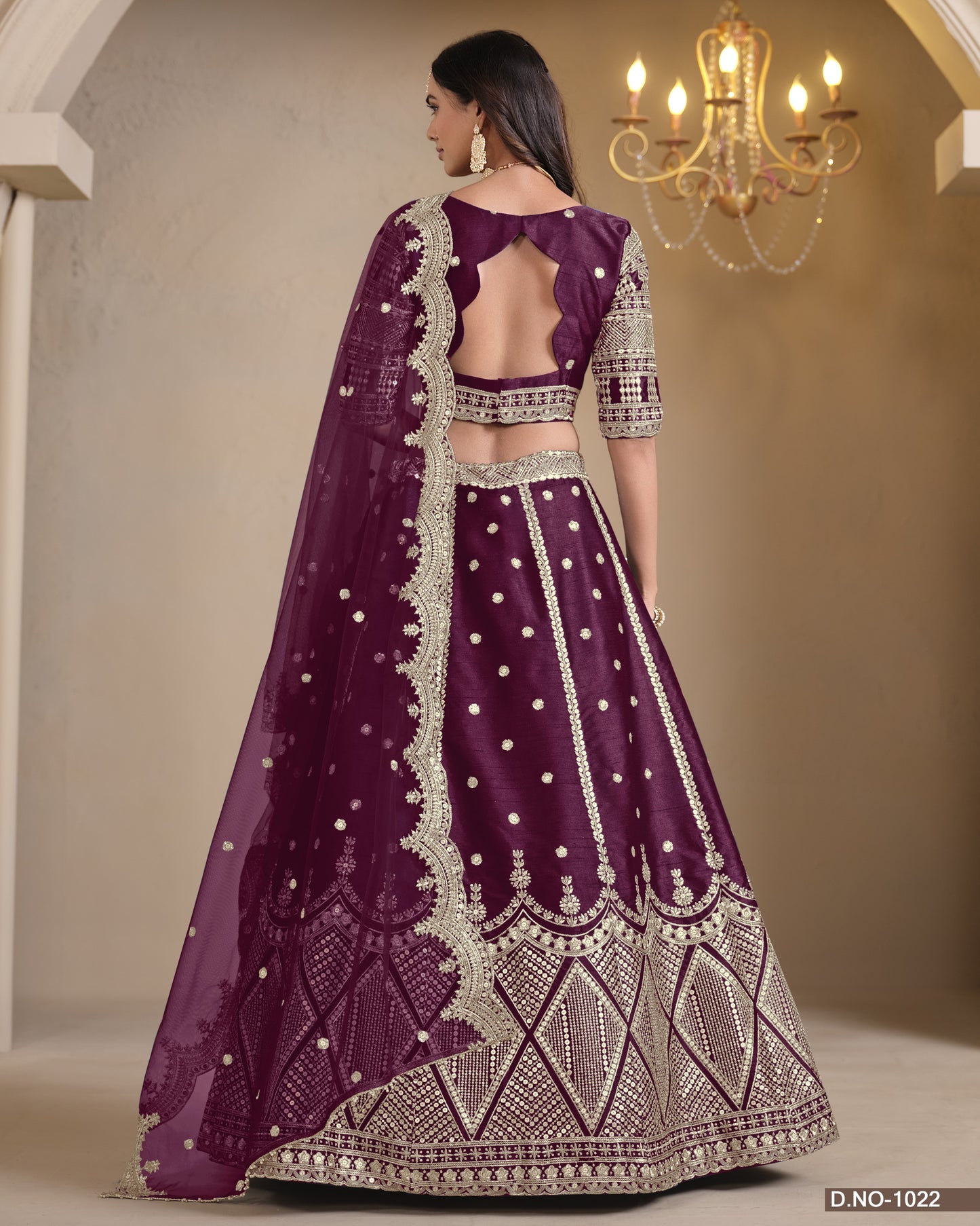 Purple embroidered traditional outfit with a chandelier in the background