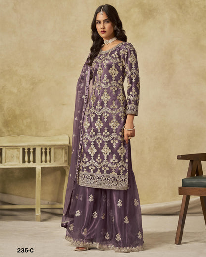 Woman wearing a purple embroidered traditional outfit with a beige background