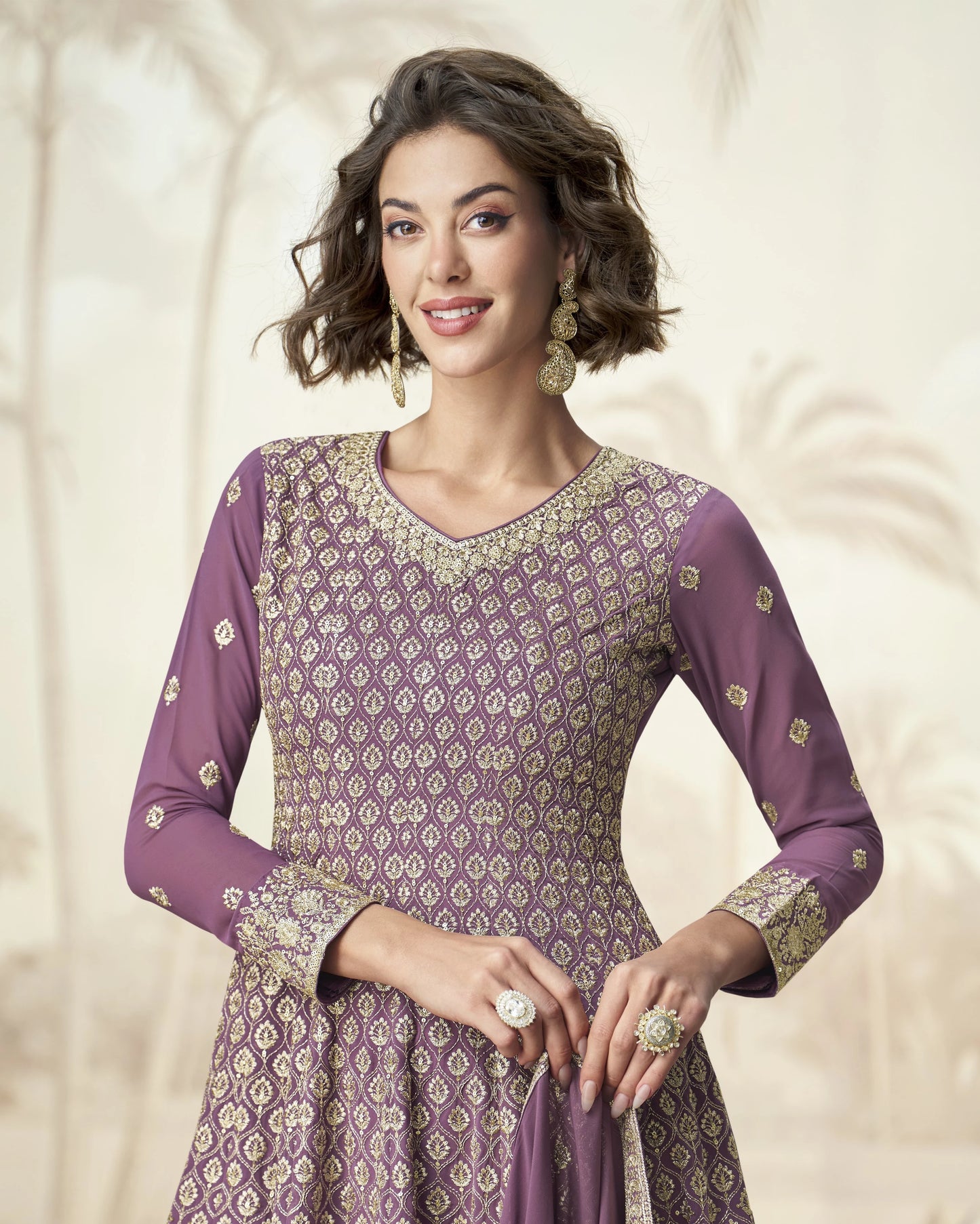 Woman wearing a purple patterned dress with a plain background