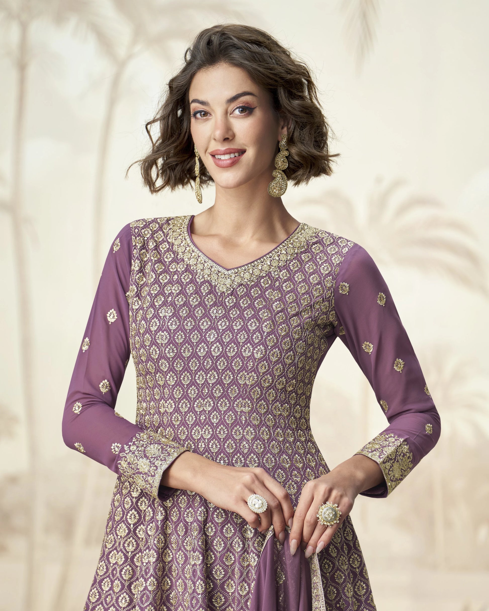 Woman wearing a purple patterned dress with a plain background