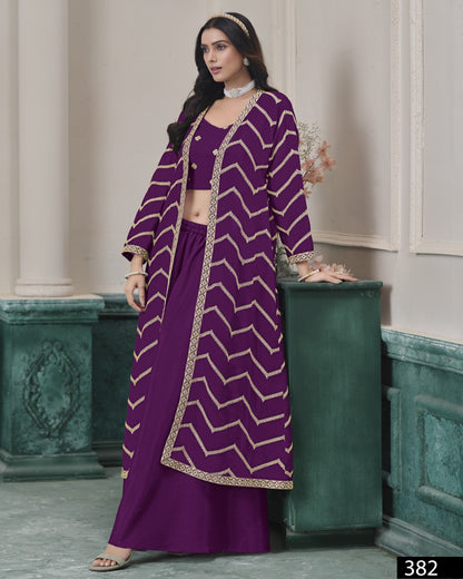 Woman wearing a purple traditional outfit with a patterned jacket indoors.