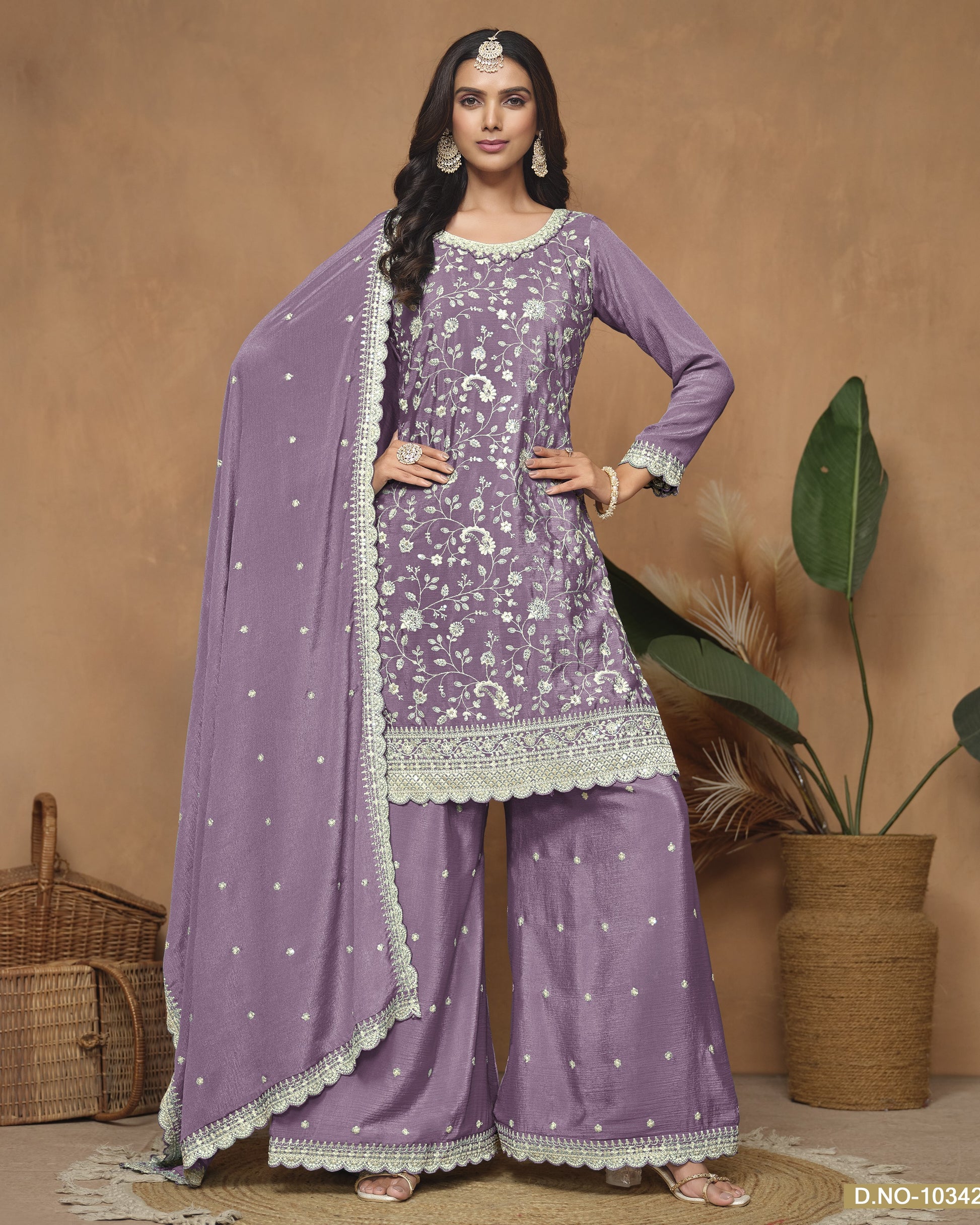 Woman wearing a purple traditional outfit with white patterns against a beige background