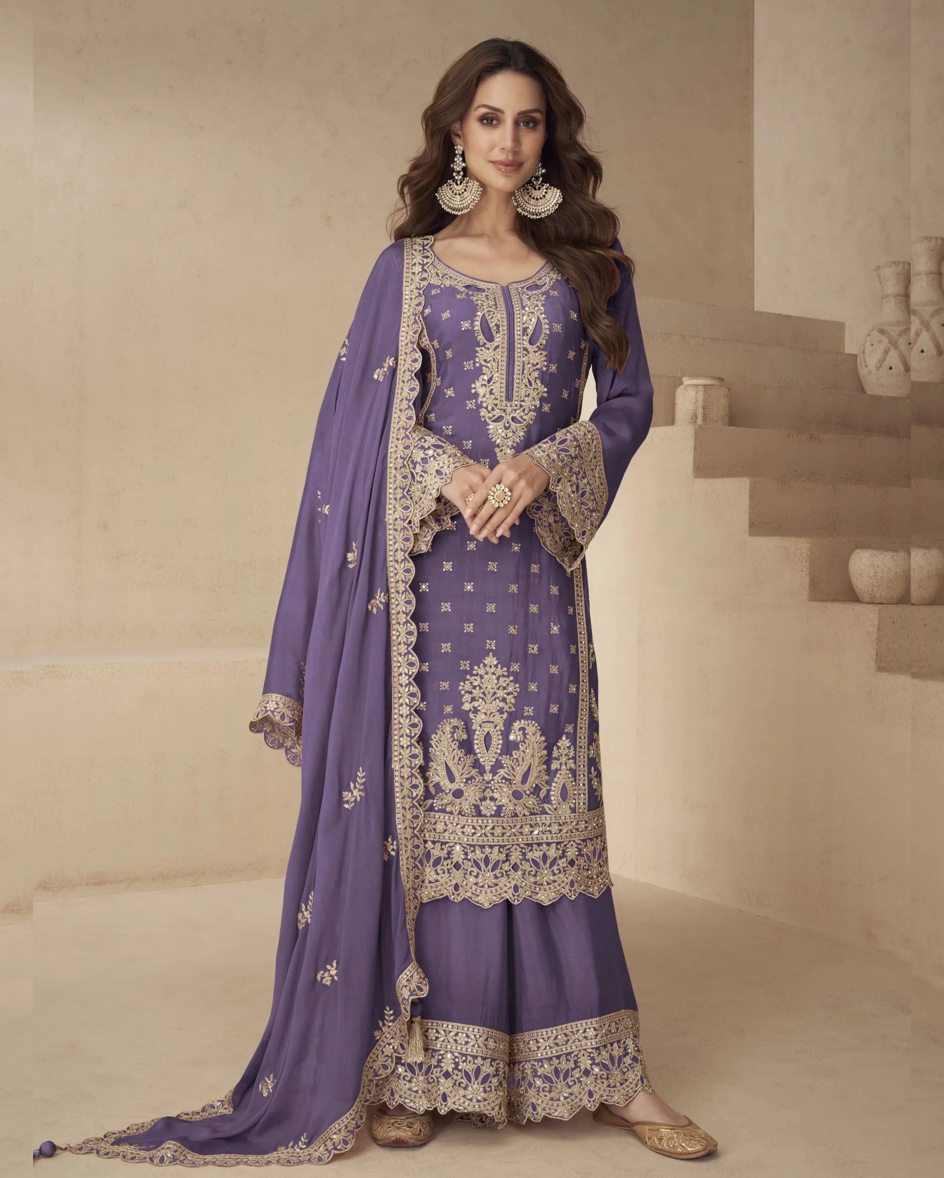 Woman wearing a purple embroidered traditional outfit with a beige background