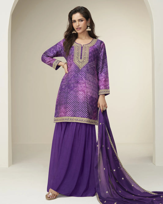 Woman wearing a purple embroidered traditional outfit with a white background