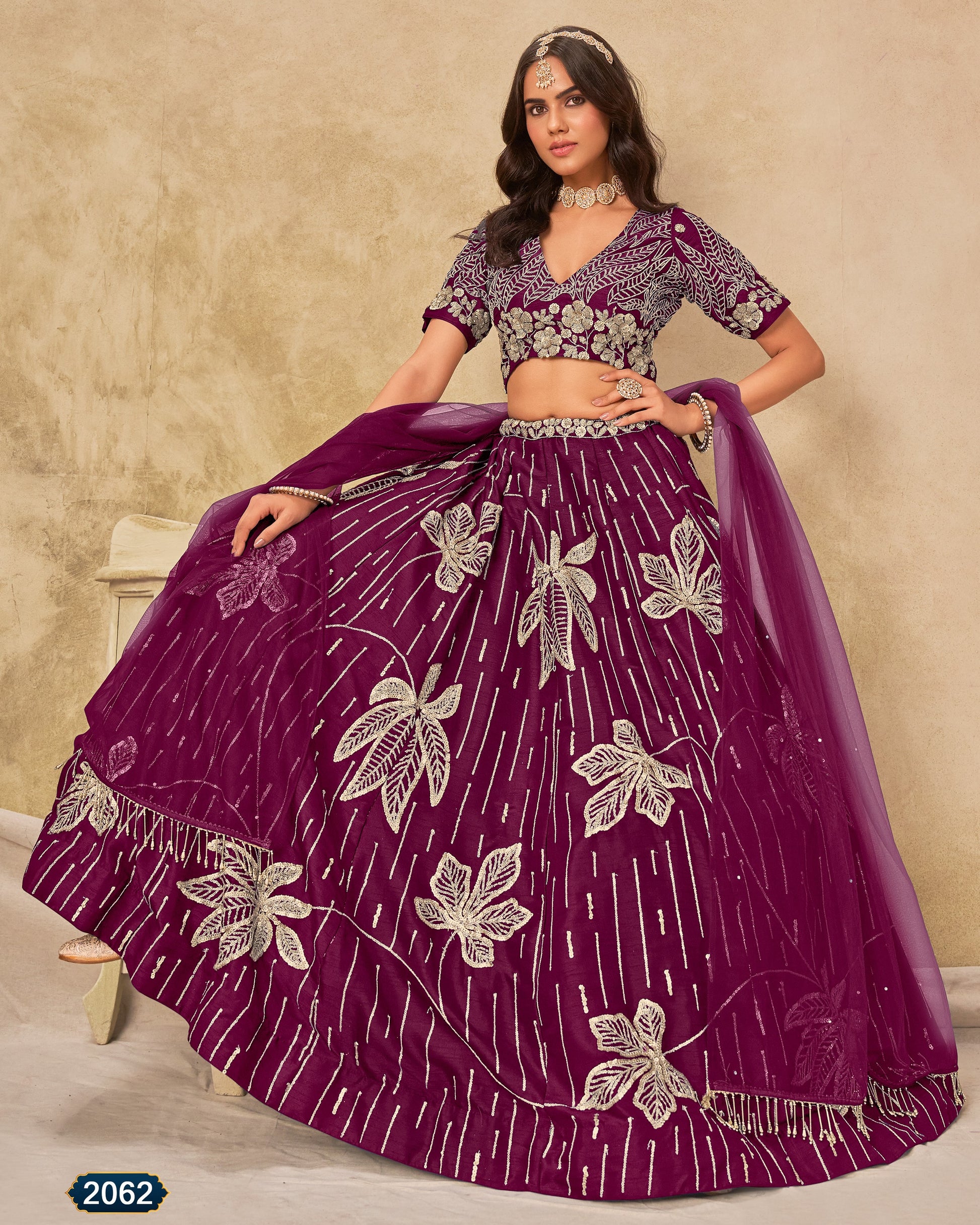 Woman wearing a purple embroidered traditional outfit with a beige background