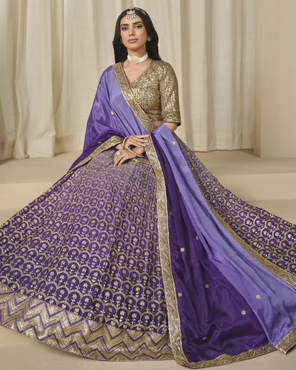 Woman wearing a traditional purple and gold saree with a plain background