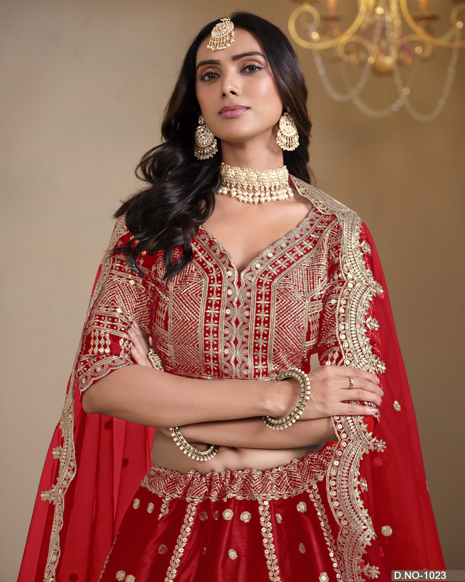Woman in a red and gold traditional outfit with jewelry against a beige background